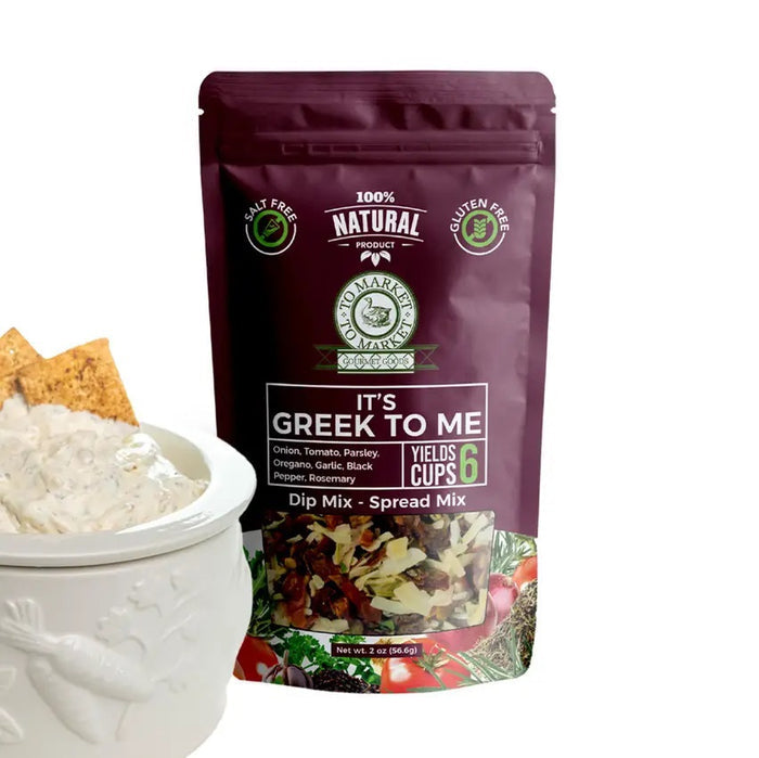 A purple bag of TO MARKET - IT’S GREEK TO ME DIP MIX by TO MARKET- DIPS & SPREADS sits beside a bowl of white dip served with crackers. The packaging highlights a 6-cup yield and features key ingredients like onion, parsley, and oregano, making it an ideal foundation for a Mediterranean spread—just add feta cheese and kalamata olives for an authentic flair.