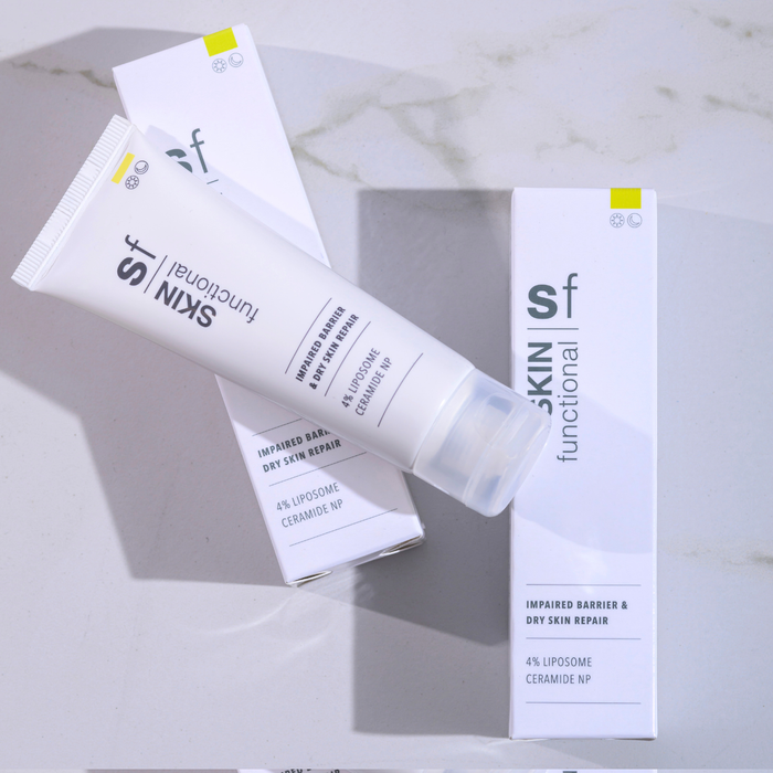 Skincare product packaging on a marble surface