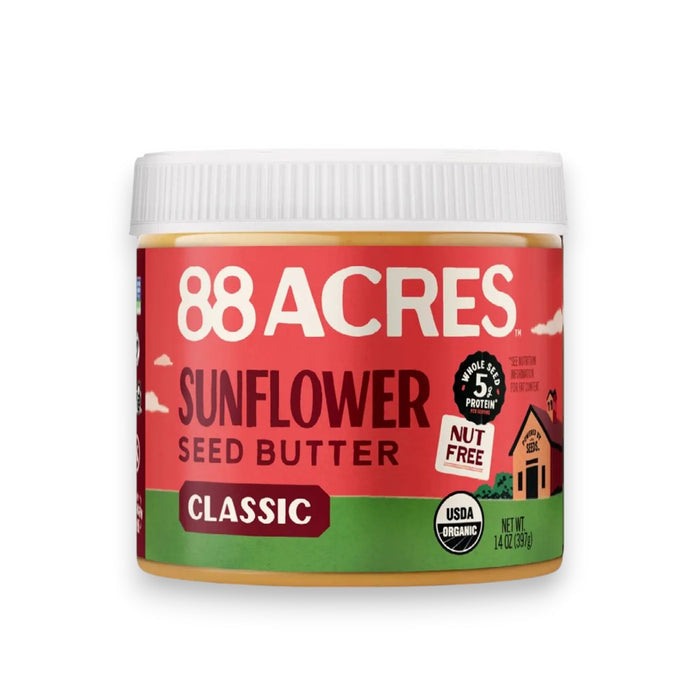 A 14 oz jar of 88 ACRES- SUNFLOWER SEED BUTTER JAR by 88 ACRES, featuring a green and red label that highlights its nut-free status, USDA organic certification, and 5g of protein per serving. This sunflower seed butter is a pantry staple, crafted with care and lightly sweetened with Vermont maple sugar.
