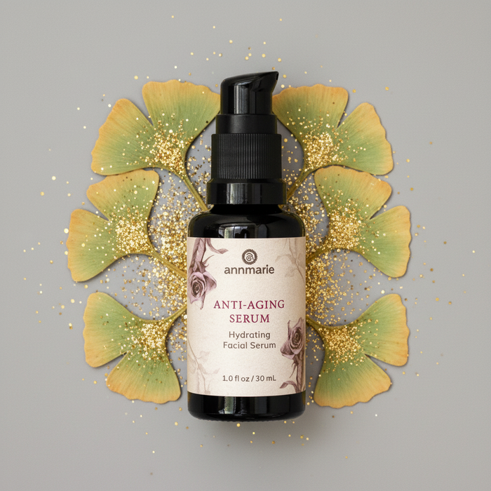 Anti-aging serum bottle with decorative ginkgo leaves on a gray background