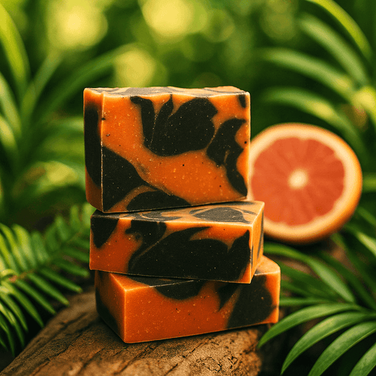 Grapefruit Palmarosa Bar Soap - Soap Boutique stacked on a log with citrus backdrop.