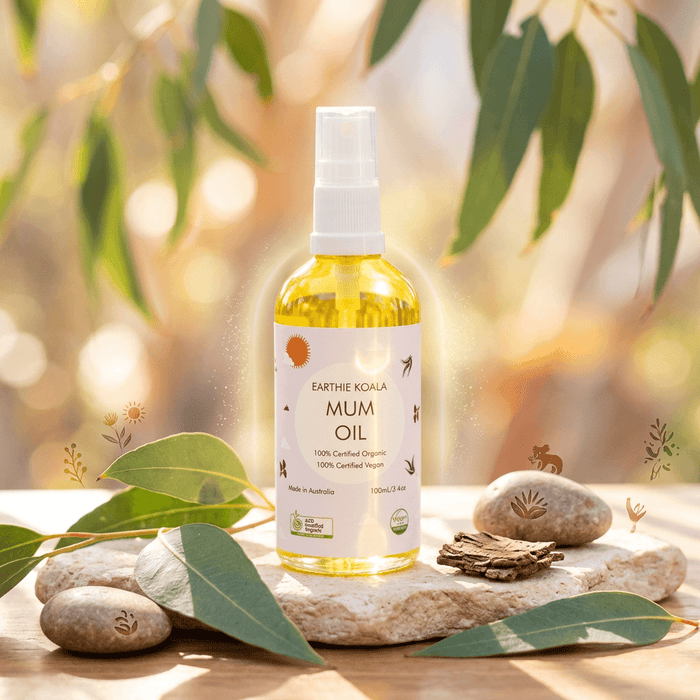 Mum Hydrating Body Oil with Turmeric 100ml - Earthie Koala in a natural setting with stones and leaves.