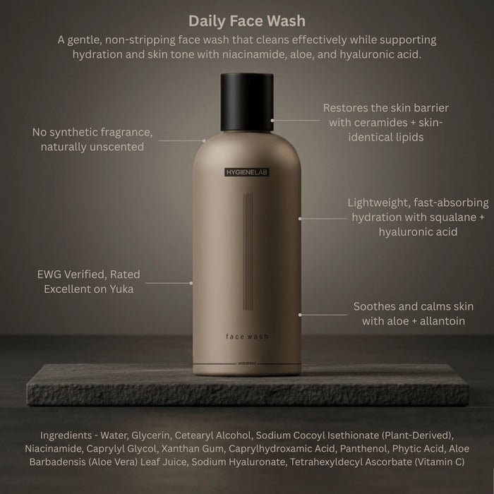 A person dispenses HYGIENELAB - FACE WASH, UNSCENTED from a brown bottle onto their open palm against a neutral background.