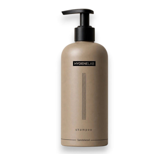 A sandalwood-inspired graphic features the HYGIENELAB - SHAMPOO, SANDALWOOD by HYGIENELAB, with text highlighting its essential oils, botanical extracts, and clean ingredients. The design includes smooth stones, sandalwood sticks, and leaves on a neutral background, complemented by icons and descriptive headings to showcase the benefits of this natural shampoo and sulfate-free formula.