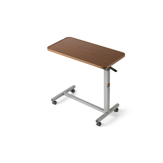 A rectangular overbed table with a wood top sits on four small wheels against a white background.