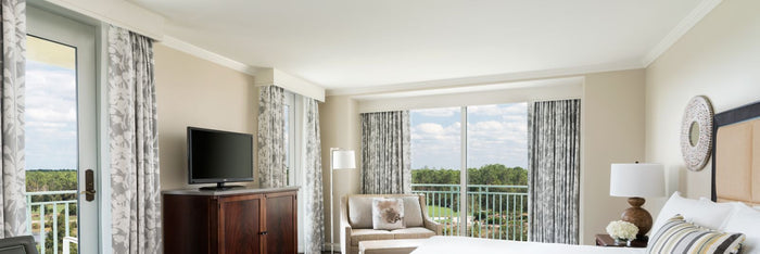 Modern bedroom with a view of a scenic balcony.