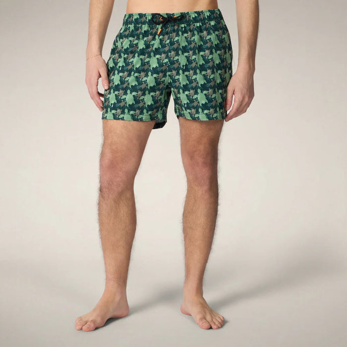 SAVE THE DUCK ADEMIR swim trunks in green and gray turtle camouflage are crafted from recycled polyester, featuring a black drawstring and orange tag. These quick-dry men's shorts are shown on a plain background.