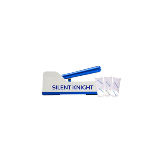 A pill crusher labeled "SILENT KNIGHT" sits idle; three small pouches are adjacent to the device. The crusher is two-toned, with white and blue plastic.