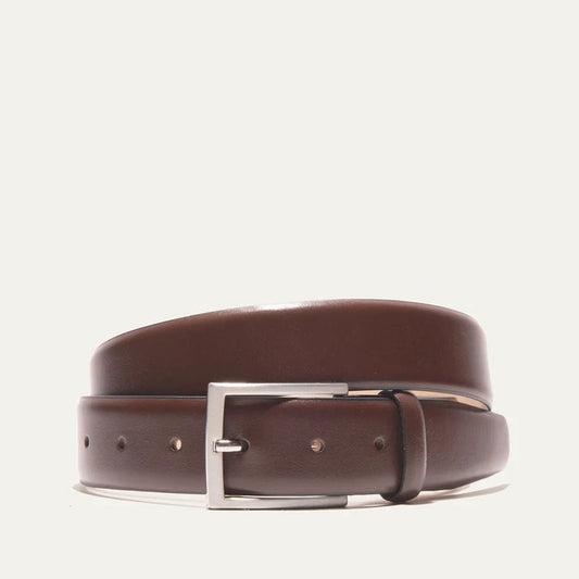 The WILL LEATHER GOODS Glazed Calfskin Belt in Cognac features a silver rectangular buckle and is shown diagonally on a plain white background.