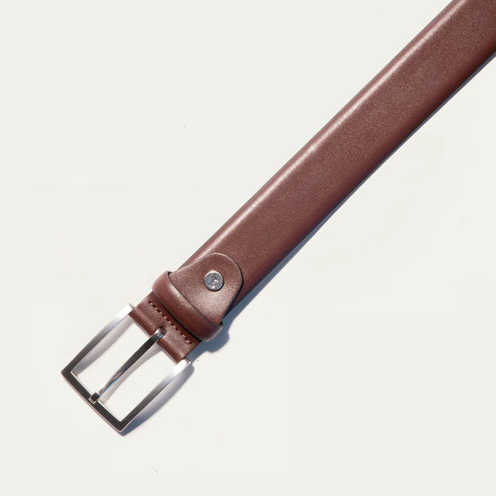 The WILL LEATHER GOODS Glazed Calfskin Belt in Cognac features a silver rectangular buckle and is shown diagonally on a plain white background.